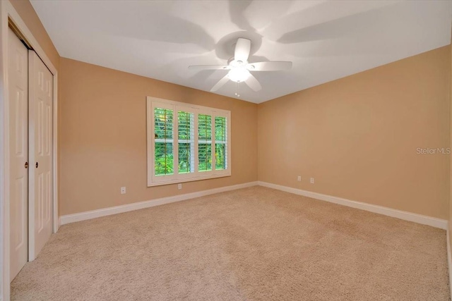 3769 Grove View Ln, Port Orange, FL 32129 - unfurnished bedroom with carpet floors, a closet, and ceiling fan