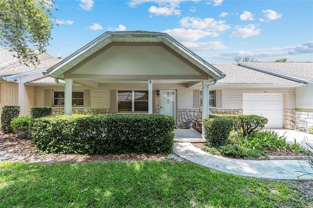9065 SW 82nd Ter Unit G, Ocala, FL 34481 - view of front facade with stone siding, a porch, and an attached garage