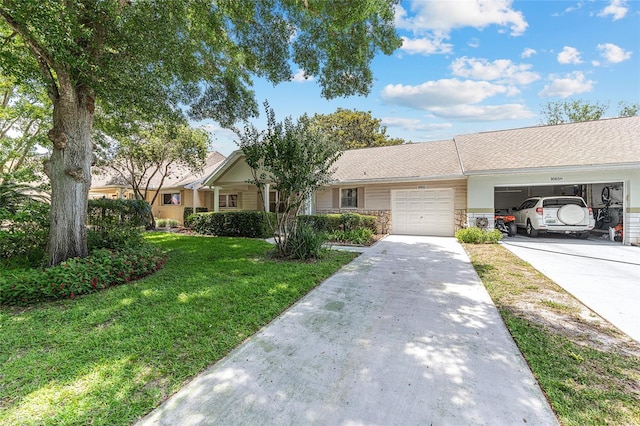 9065 SW 82nd Ter Unit G, Ocala, FL 34481 - ranch-style house featuring an attached garage, driveway, a front yard, and stone siding
