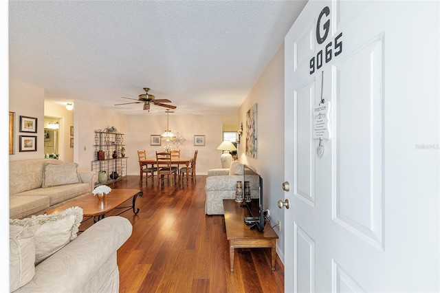 9065 SW 82nd Ter Unit G, Ocala, FL 34481 - living area featuring dark wood-style flooring, a ceiling fan, and a textured ceiling