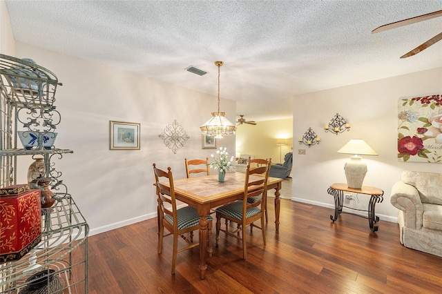 9065 SW 82nd Ter Unit G, Ocala, FL 34481 - dining area featuring wood finished floors, a textured ceiling, a ceiling fan, and a chandelier