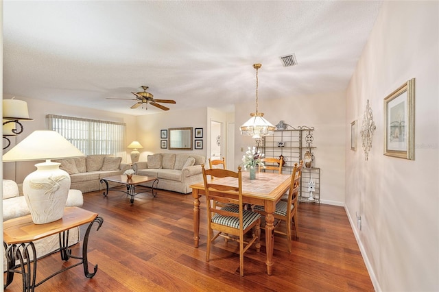 9065 SW 82nd Ter Unit G, Ocala, FL 34481 - dining room featuring a ceiling fan and dark wood-style floors