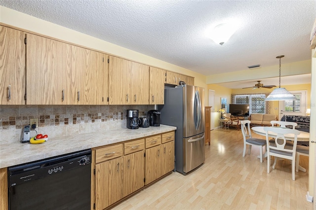 9065 SW 82nd Ter Unit G, Ocala, FL 34481 - kitchen with dishwashing machine, freestanding refrigerator, a ceiling fan, light wood-style flooring, and decorative backsplash