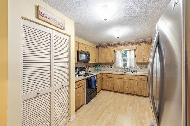 9065 SW 82nd Ter Unit G, Ocala, FL 34481 - kitchen featuring freestanding refrigerator, electric stove, black microwave, light countertops, and light wood-type flooring