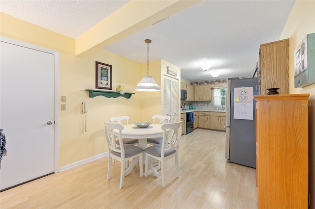9065 SW 82nd Ter Unit G, Ocala, FL 34481 - dining space with light wood finished floors and a textured ceiling