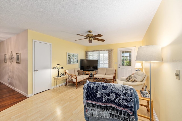 9065 SW 82nd Ter Unit G, Ocala, FL 34481 - living room with light wood-style floors, a ceiling fan, and a textured ceiling