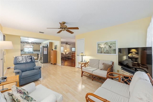 9065 SW 82nd Ter Unit G, Ocala, FL 34481 - living room featuring a ceiling fan and light wood-style floors