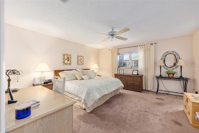 9065 SW 82nd Ter Unit G, Ocala, FL 34481 - bedroom with light carpet, a textured ceiling, and a ceiling fan