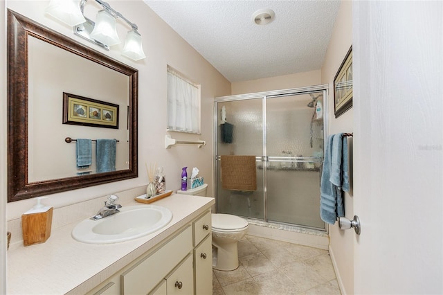 9065 SW 82nd Ter Unit G, Ocala, FL 34481 - bathroom with vanity, a stall shower, a textured ceiling, and tile patterned floors