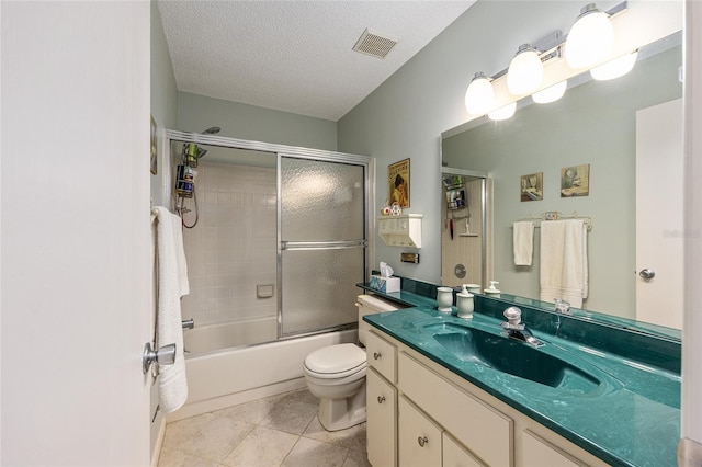 9065 SW 82nd Ter Unit G, Ocala, FL 34481 - bathroom featuring vanity, enclosed tub / shower combo, a textured ceiling, and tile patterned flooring