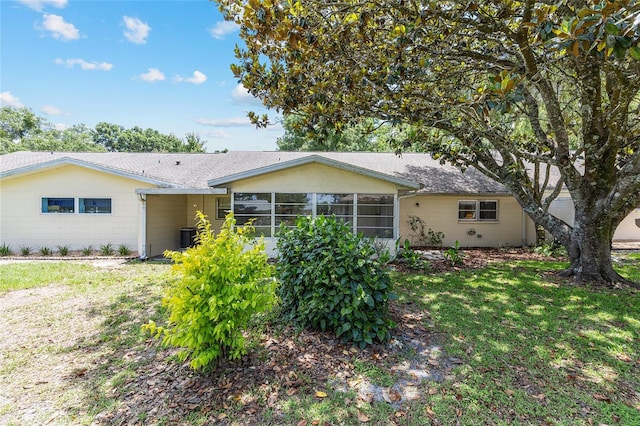 9065 SW 82nd Ter Unit G, Ocala, FL 34481 - back of house with a sunroom, roof with shingles, and a lawn