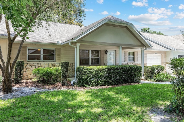 9065 SW 82nd Ter Unit G, Ocala, FL 34481 - view of front of property with stone siding, an attached garage, and a front lawn