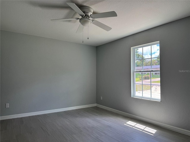 6422 NW 62nd Pl, Ocala, FL 34482 - unfurnished room featuring dark wood-type flooring, ceiling fan, and a textured ceiling
