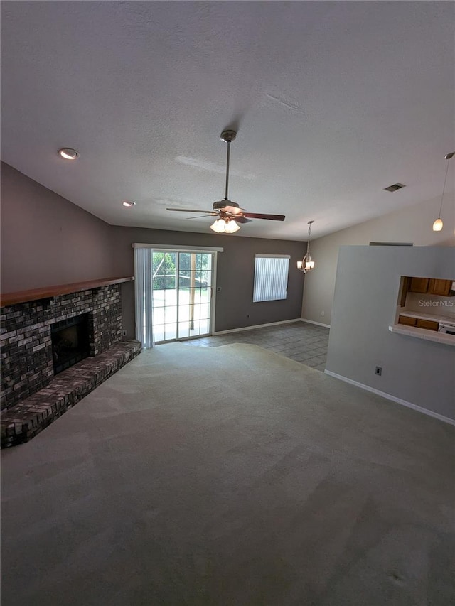 3650 SE 55th Ct, Ocala, FL 34480 - unfurnished living room with carpet flooring, lofted ceiling, ceiling fan, a fireplace, and a chandelier