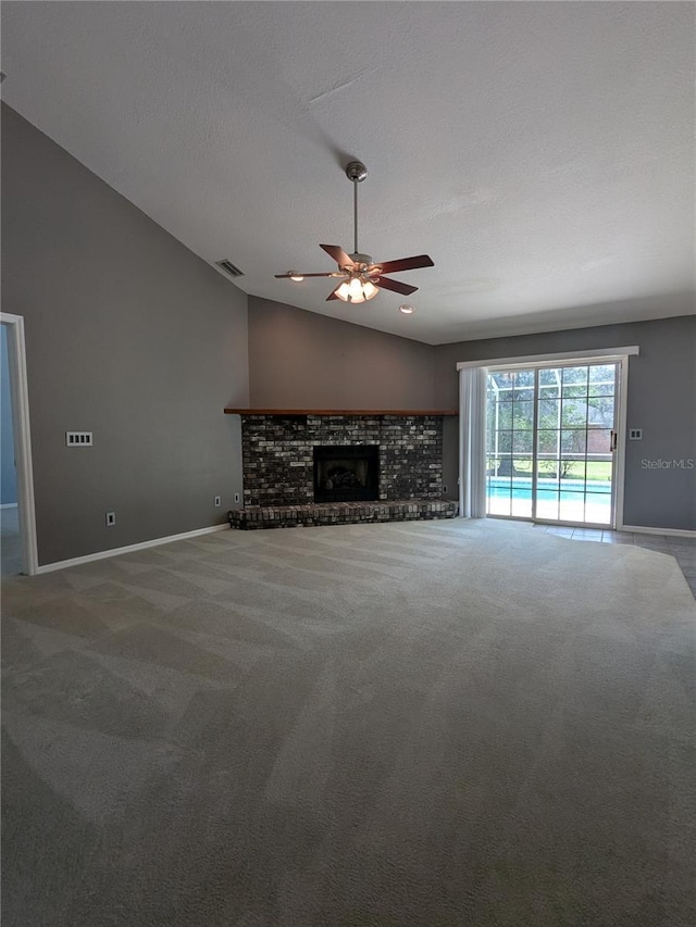 3650 SE 55th Ct, Ocala, FL 34480 - unfurnished living room with ceiling fan, carpet floors, a brick fireplace, and vaulted ceiling