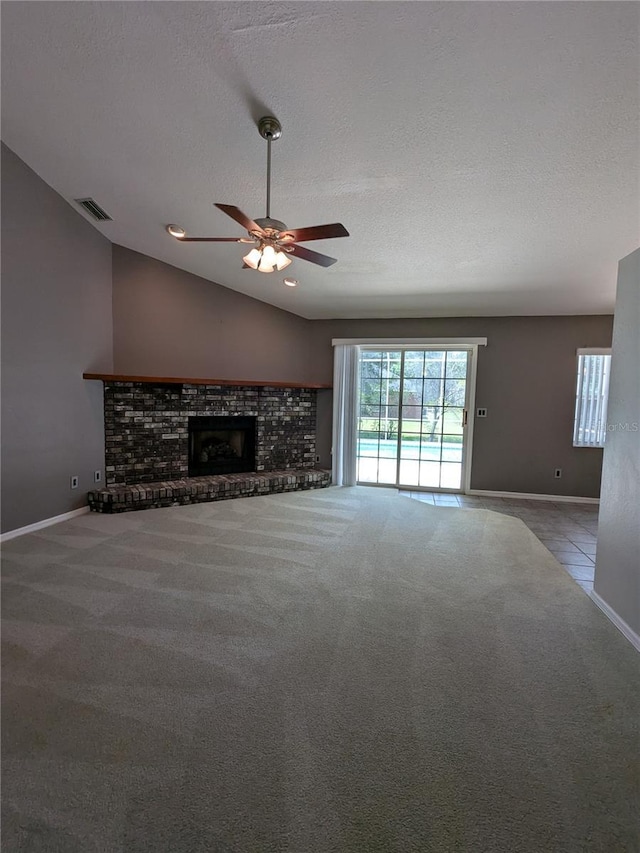 3650 SE 55th Ct, Ocala, FL 34480 - unfurnished living room with carpet, a ceiling fan, a textured ceiling, a brick fireplace, and vaulted ceiling