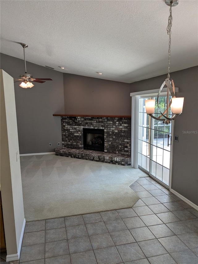 3650 SE 55th Ct, Ocala, FL 34480 - unfurnished living room featuring a textured ceiling, a chandelier, carpet flooring, tile patterned flooring, and a brick fireplace