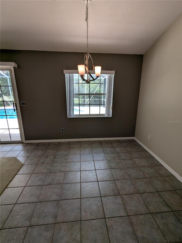 3650 SE 55th Ct, Ocala, FL 34480 - unfurnished room featuring a chandelier and tile patterned floors
