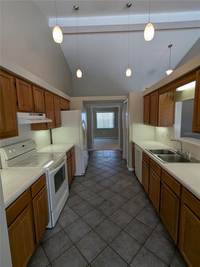 3650 SE 55th Ct, Ocala, FL 34480 - kitchen featuring white appliances, under cabinet range hood, tile counters, backsplash, and high vaulted ceiling