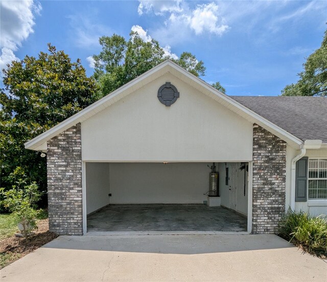 3650 SE 55th Ct, Ocala, FL 34480 - garage featuring gas water heater and concrete driveway