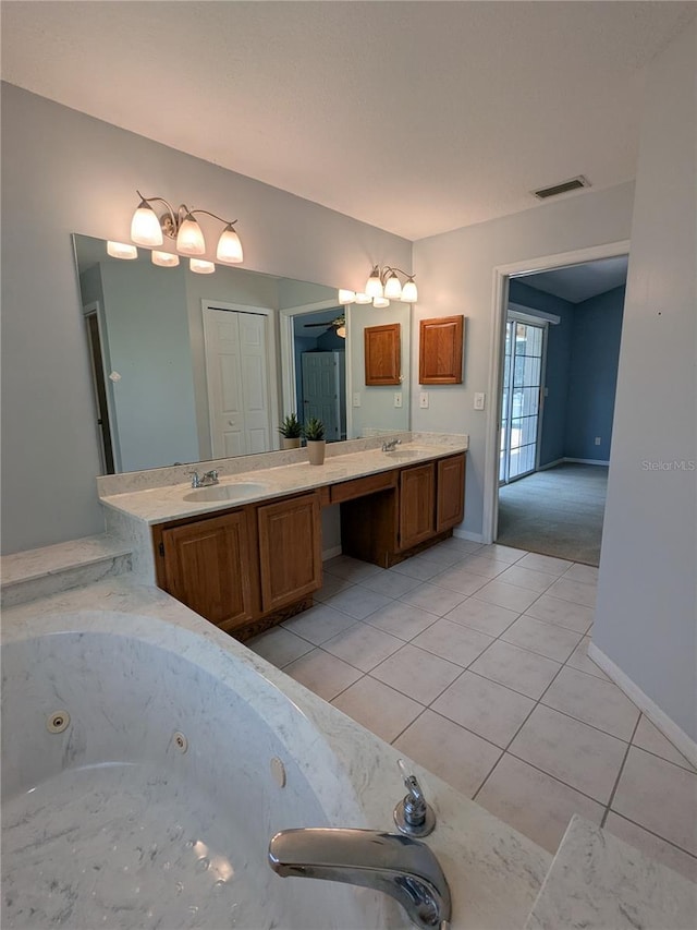 3650 SE 55th Ct, Ocala, FL 34480 - bathroom with double vanity, tile patterned flooring, and a jetted tub