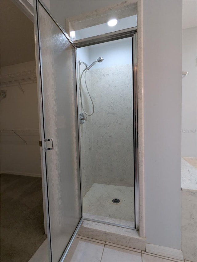 3650 SE 55th Ct, Ocala, FL 34480 - full bath with a stall shower, a spacious closet, and tile patterned flooring