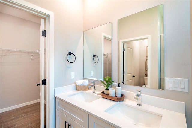 7364 SW 133rd Loop NE, Ocala, FL 34473 - bathroom with double vanity, wood finished floors, and a spacious closet