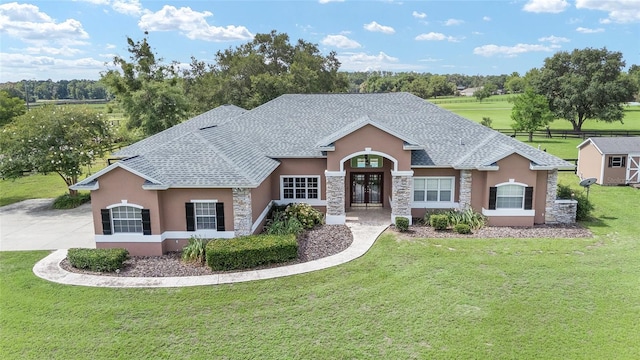 7220 NW 83rd Ter, Ocala, FL 34482 - view of front of property with stucco siding, french doors, stone siding, and a front yard
