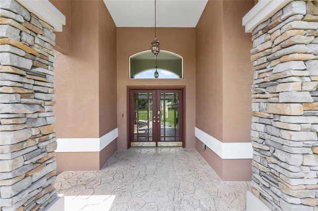 7220 NW 83rd Ter, Ocala, FL 34482 - doorway to property featuring french doors, stone siding, and stucco siding