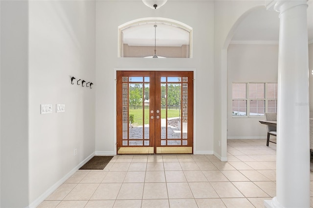 7220 NW 83rd Ter, Ocala, FL 34482 - entrance foyer with french doors, light tile patterned floors, arched walkways, ornamental molding, and a towering ceiling