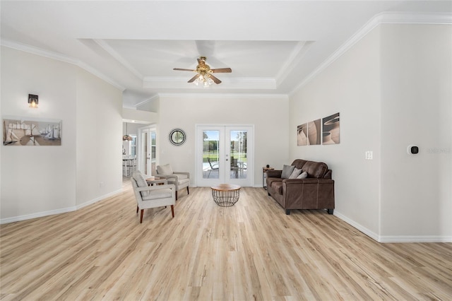 7220 NW 83rd Ter, Ocala, FL 34482 - living area featuring a raised ceiling, a ceiling fan, wood finished floors, french doors, and crown molding