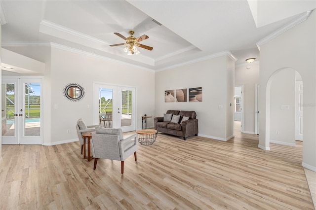 7220 NW 83rd Ter, Ocala, FL 34482 - living room featuring french doors, plenty of natural light, a raised ceiling, light wood-style floors, and crown molding