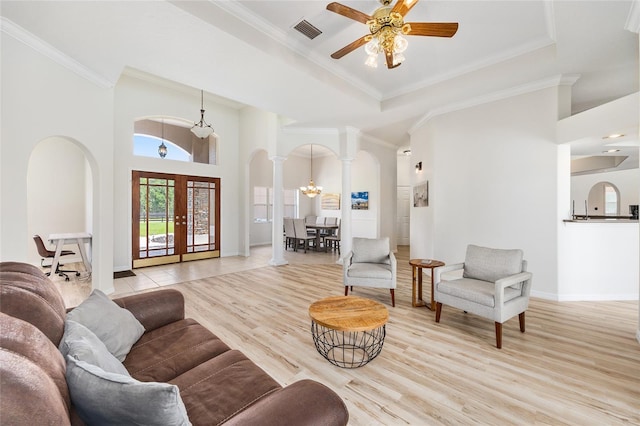 7220 NW 83rd Ter, Ocala, FL 34482 - living room with arched walkways, decorative columns, ornamental molding, ceiling fan, and wood finished floors