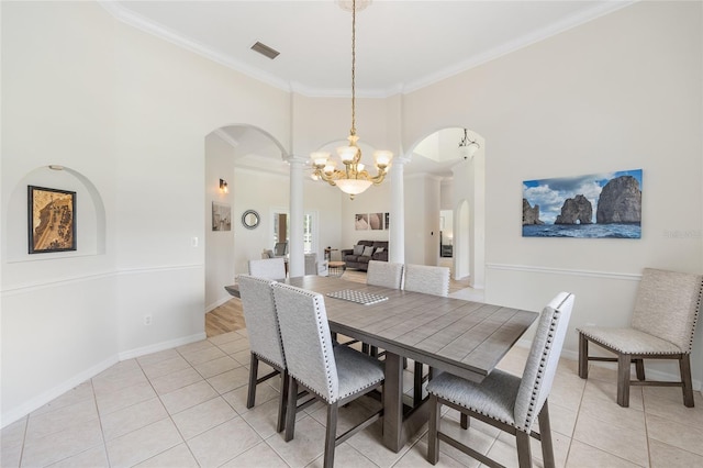 7220 NW 83rd Ter, Ocala, FL 34482 - dining room featuring arched walkways, light tile patterned flooring, decorative columns, crown molding, and a towering ceiling