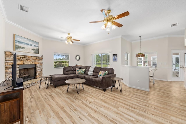 7220 NW 83rd Ter, Ocala, FL 34482 - living room featuring light wood-type flooring, a ceiling fan, crown molding, and a fireplace
