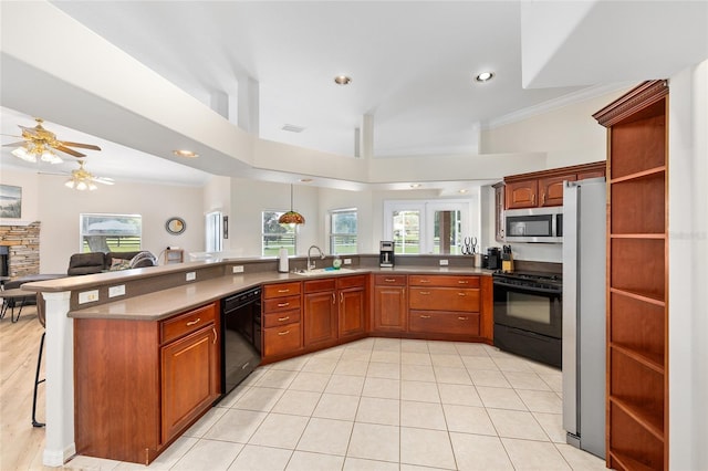 7220 NW 83rd Ter, Ocala, FL 34482 - kitchen featuring black appliances, a breakfast bar area, ceiling fan, crown molding, and open floor plan