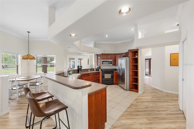 7220 NW 83rd Ter, Ocala, FL 34482 - kitchen with appliances with stainless steel finishes, ornamental molding, a kitchen bar, recessed lighting, and decorative light fixtures