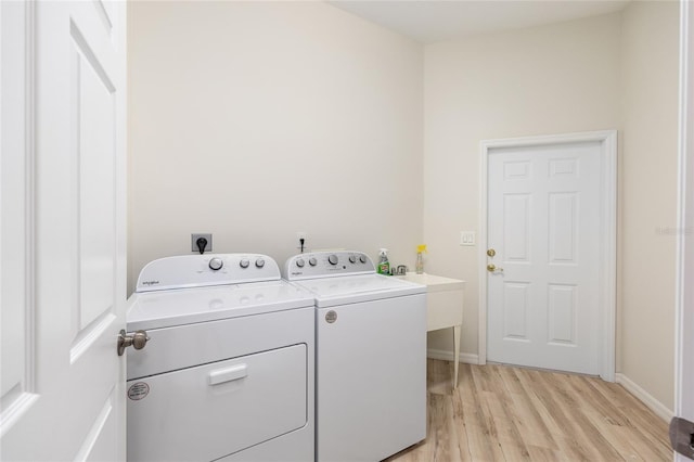 7220 NW 83rd Ter, Ocala, FL 34482 - laundry area featuring washer and dryer and light wood-type flooring