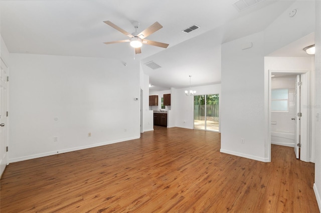 5740 NW 61st St, Ocala, FL 34482 - unfurnished living room with a chandelier, wood finished floors, a ceiling fan, and vaulted ceiling