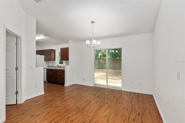 5740 NW 61st St, Ocala, FL 34482 - spare room with a chandelier and wood finished floors