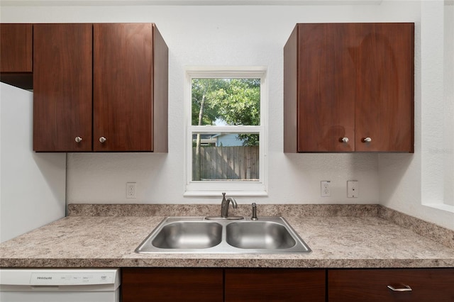 5740 NW 61st St, Ocala, FL 34482 - kitchen with dishwasher, light countertops, and dark brown cabinets