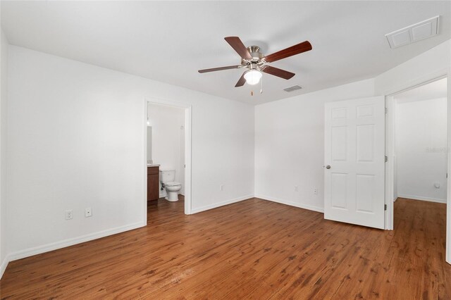 5740 NW 61st St, Ocala, FL 34482 - unfurnished bedroom featuring wood finished floors, connected bathroom, and a ceiling fan