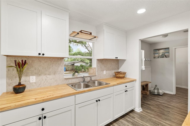 3640 SE 131st Ln, Belleview, FL 34420 - kitchen with wooden counters, tasteful backsplash, light wood-type flooring, white cabinets, and a textured ceiling