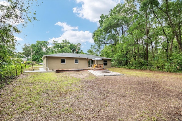 3640 SE 131st Ln, Belleview, FL 34420 - rear view of house with a deck, stucco siding, and a patio area