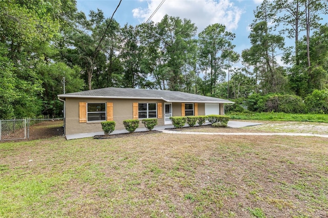 3640 SE 131st Ln, Belleview, FL 34420 - ranch-style home with a garage, stucco siding, driveway, and view of wooded area