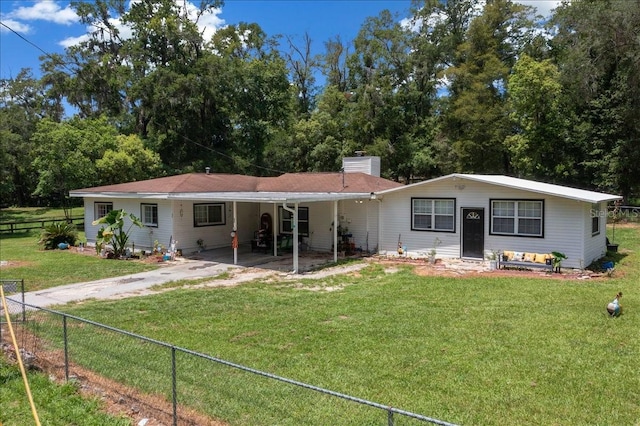 2340 NE 14th Ave, Ocala, FL 34470 - back of property with a chimney, a carport, and driveway