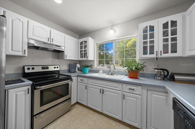 2340 NE 14th Ave, Ocala, FL 34470 - kitchen featuring stainless steel electric range oven, under cabinet range hood, dishwashing machine, and white cabinetry