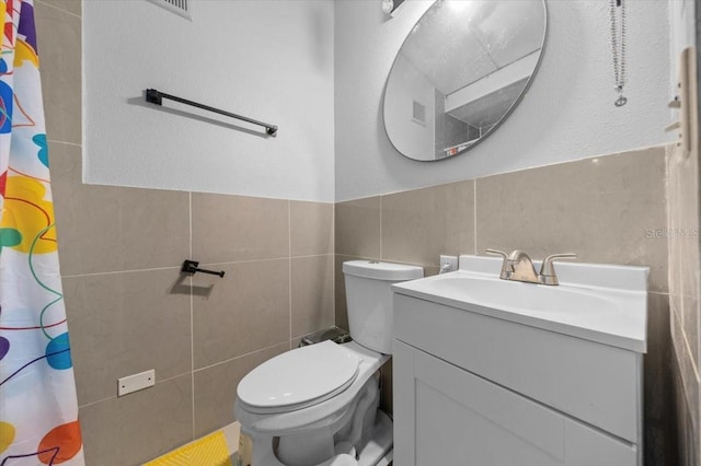2340 NE 14th Ave, Ocala, FL 34470 - bathroom with tile walls, vanity, a shower with curtain, and wainscoting
