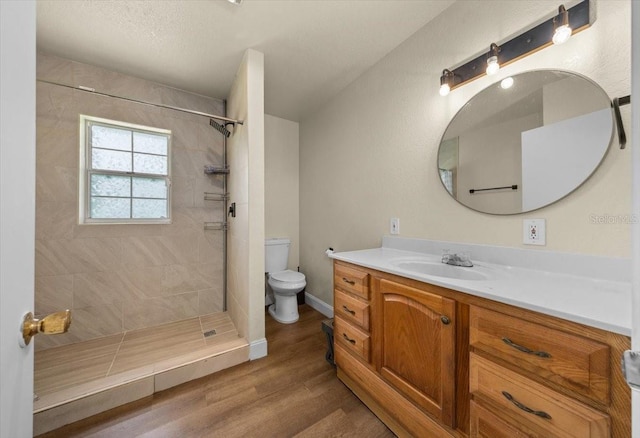 2340 NE 14th Ave, Ocala, FL 34470 - full bathroom featuring vanity, a tile shower, and wood finished floors