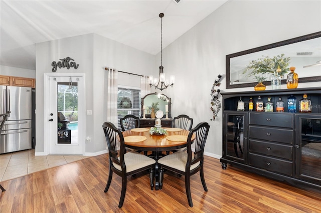 6362 N Walter Ter, Citrus Springs, FL 34434 - dining area featuring a chandelier, wood finished floors, high vaulted ceiling, and a bar